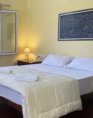 Bright guest room at Surya Villa with queen bed and window view